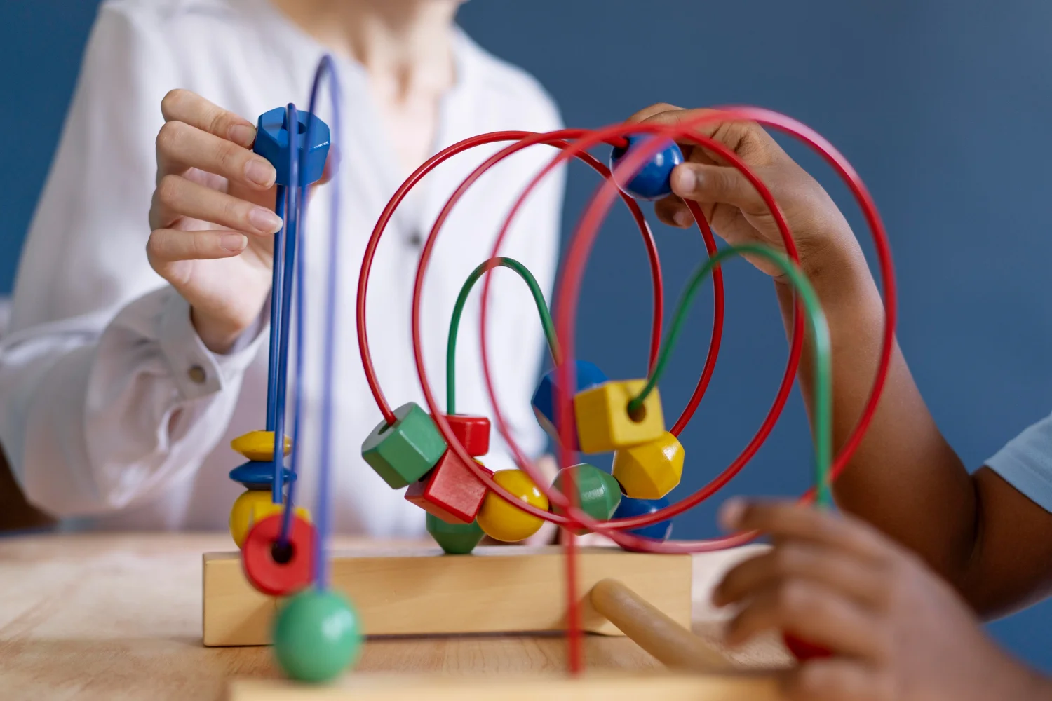 Two Children playing with pastic colorful blocks togather